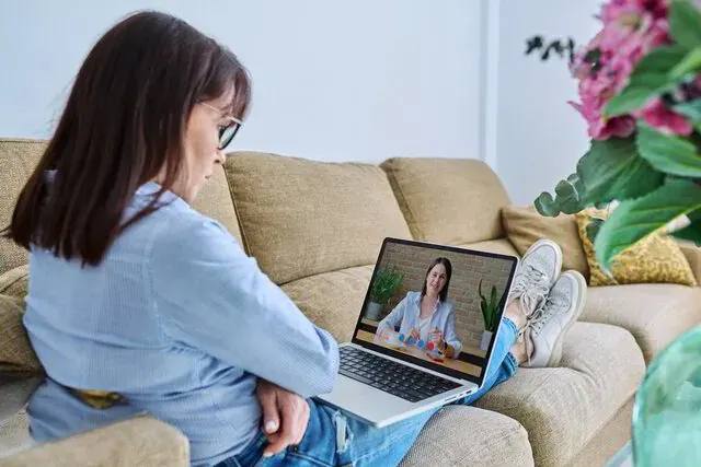 A laptop on a desk representing online video grief coaching sessions