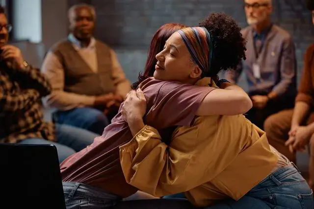 Women supporting one another during a group grief workshop in Maryland