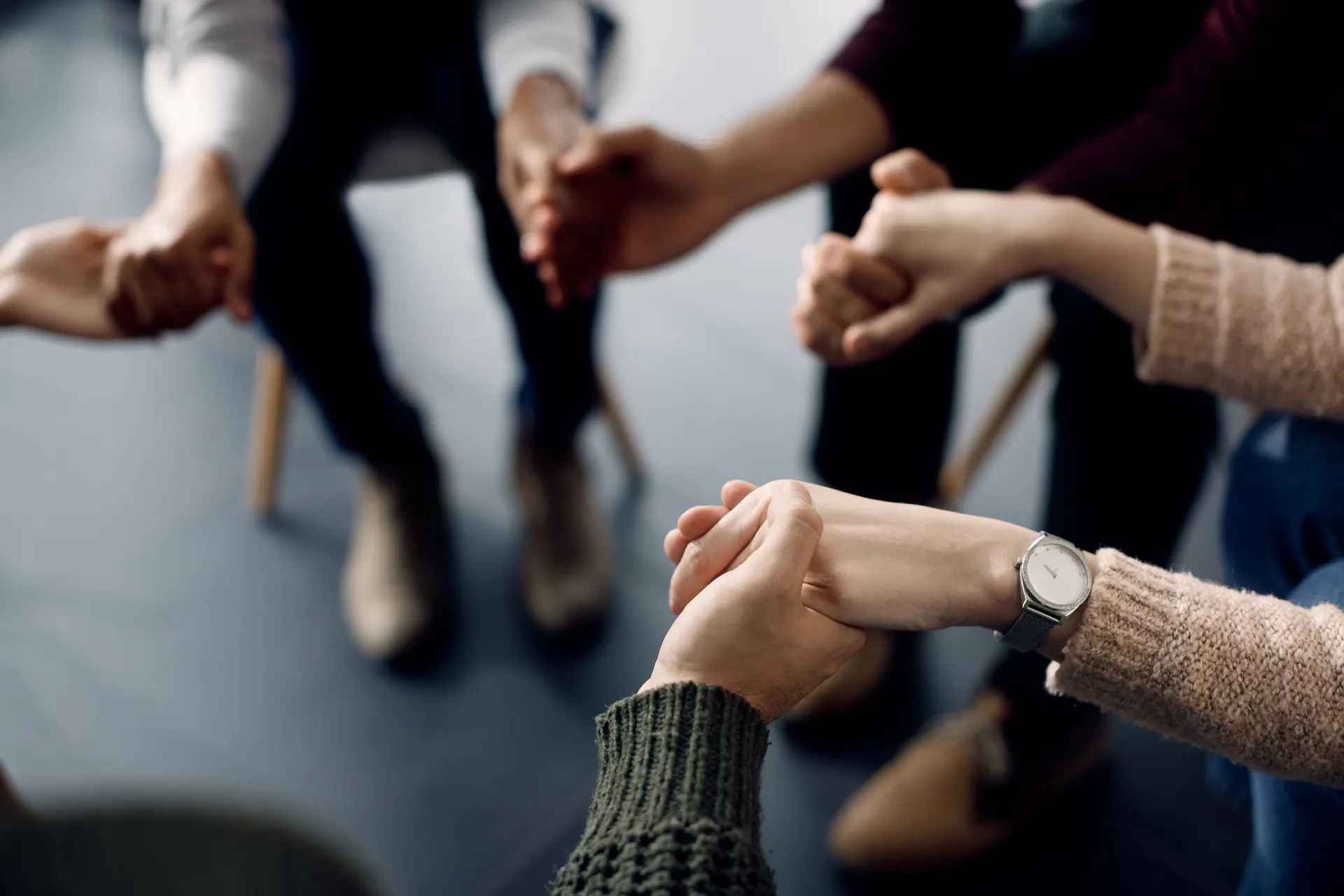Support group holding hands