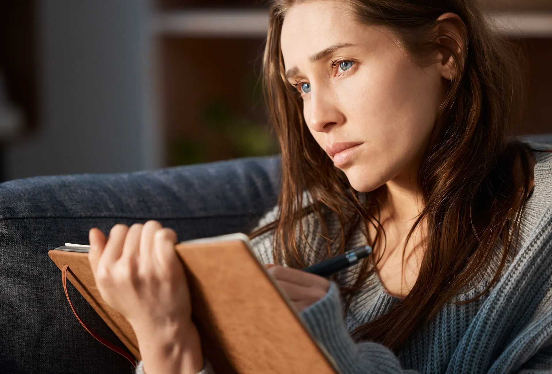 Woman journaling to process grief